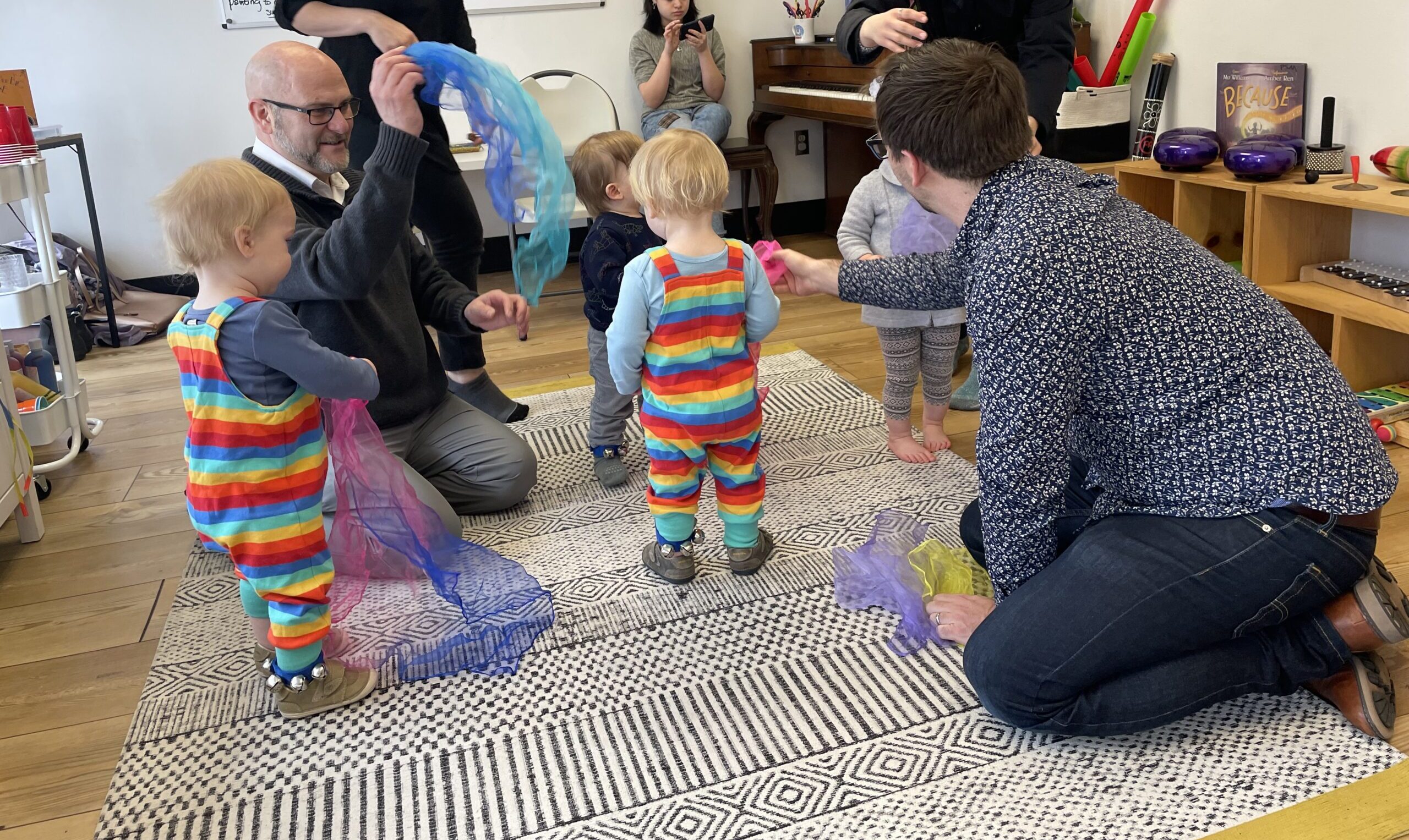 toddlers dancing with teachers, parents, and scarves